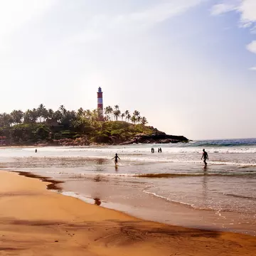 View of a lighthouse on Kovalam Beach in Kerala, India.