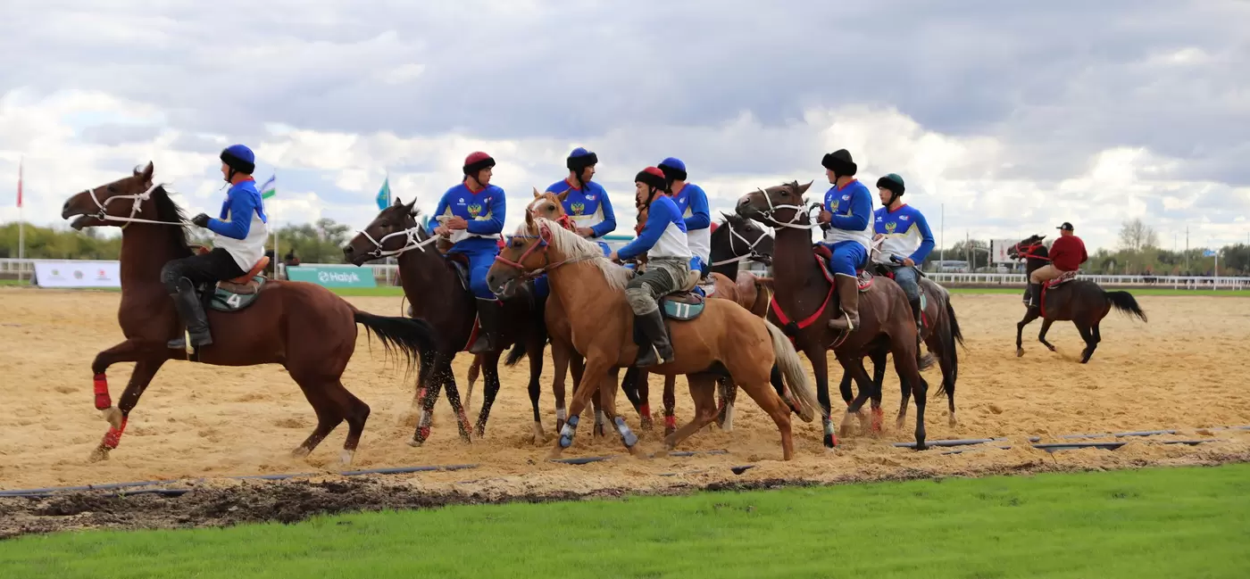 People on horseback in a sandy arena prepare to take part in a contest at the World Nomad Games.