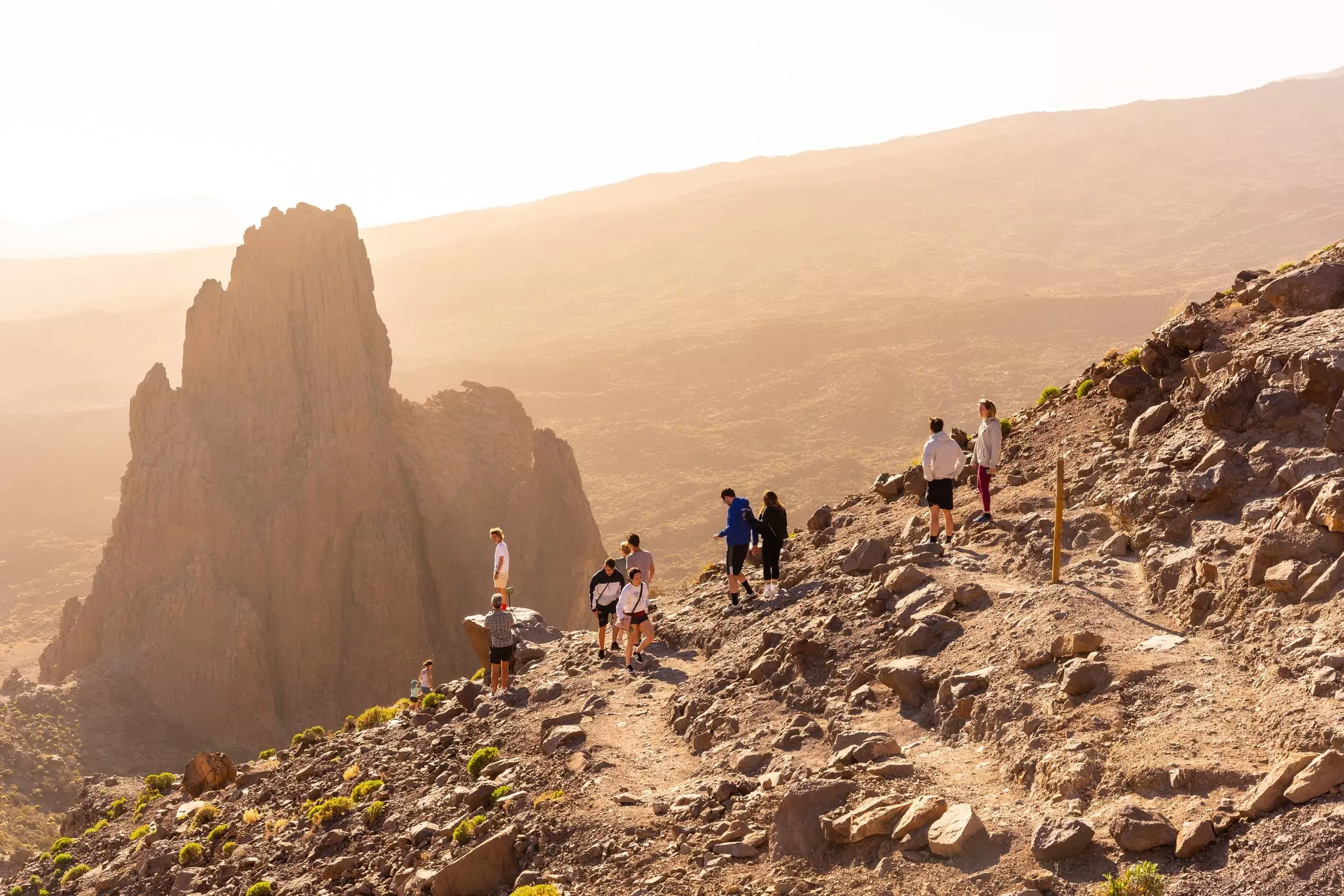 Tourists at sunset in Roques de Gracia and Roque Cinchado in the natural area of Teide in Tenerife.