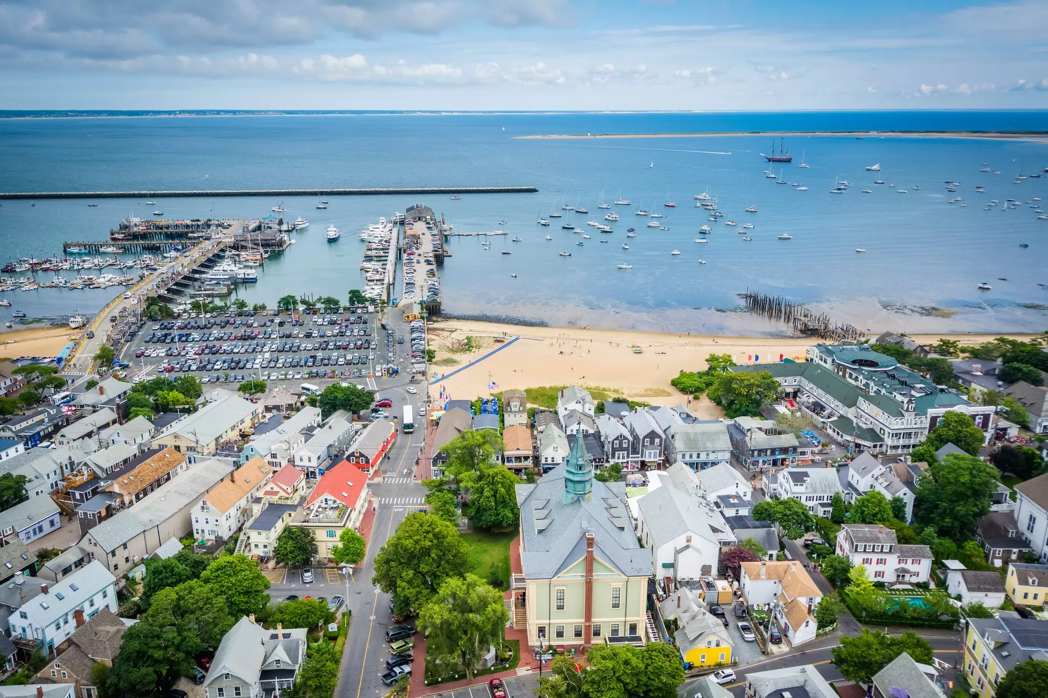 A beach, harbor and small town