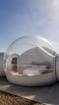 A clear globe with a bedroom inside it.