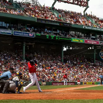 J.D. Martinez #28 of the Boston Red Sox hits a double during the fourth inning of a game against the Milwaukee Brewers on July 31, 2022 at Fenway Park in Boston, Massachusetts.