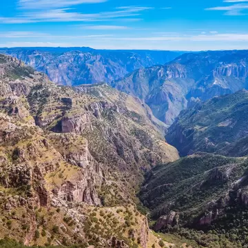 Rolling peaks and valleys of a vast canyon landscape.
