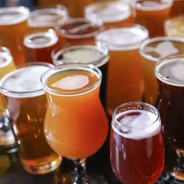 A cluster of glasses holding different varieties of craft beer