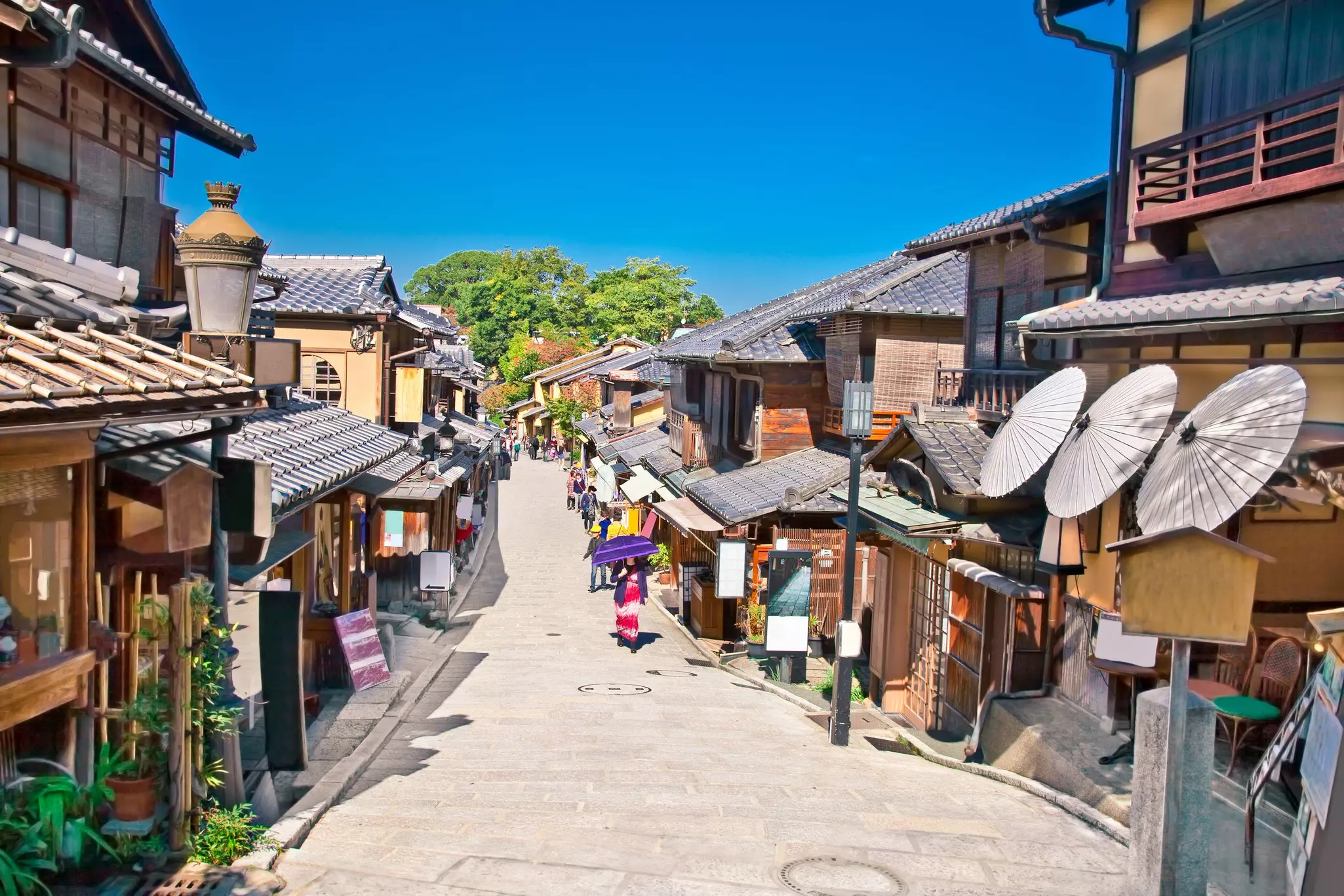 A row of traditional low-rise wooden houses lines a street