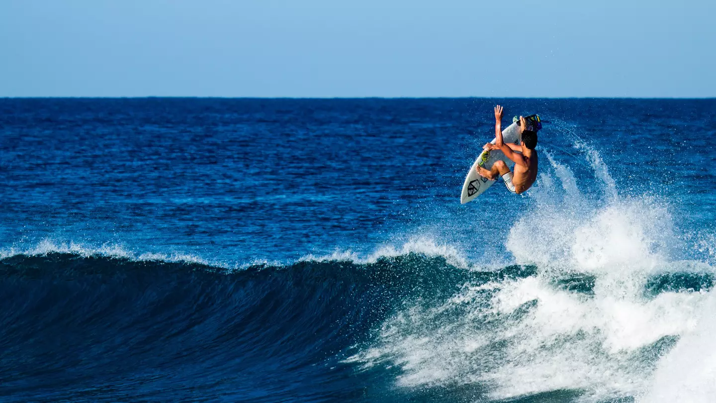 A surfer performing an aerial near Rincón