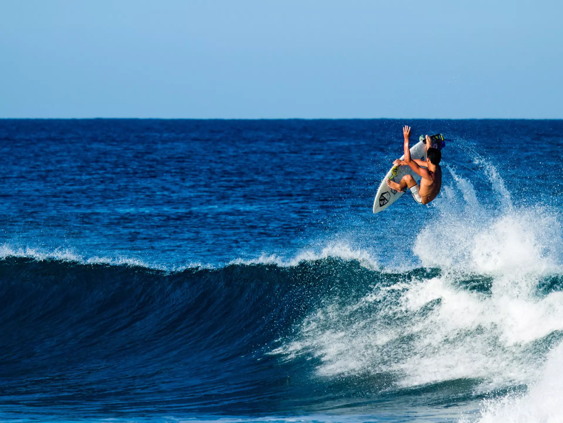 A surfer performing an aerial near Rincón
