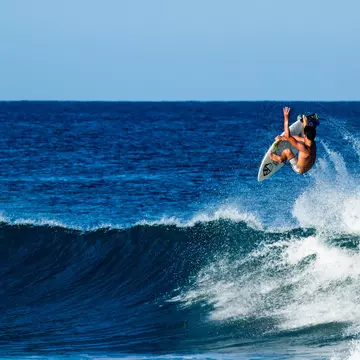 A surfer performing an aerial near Rincón
