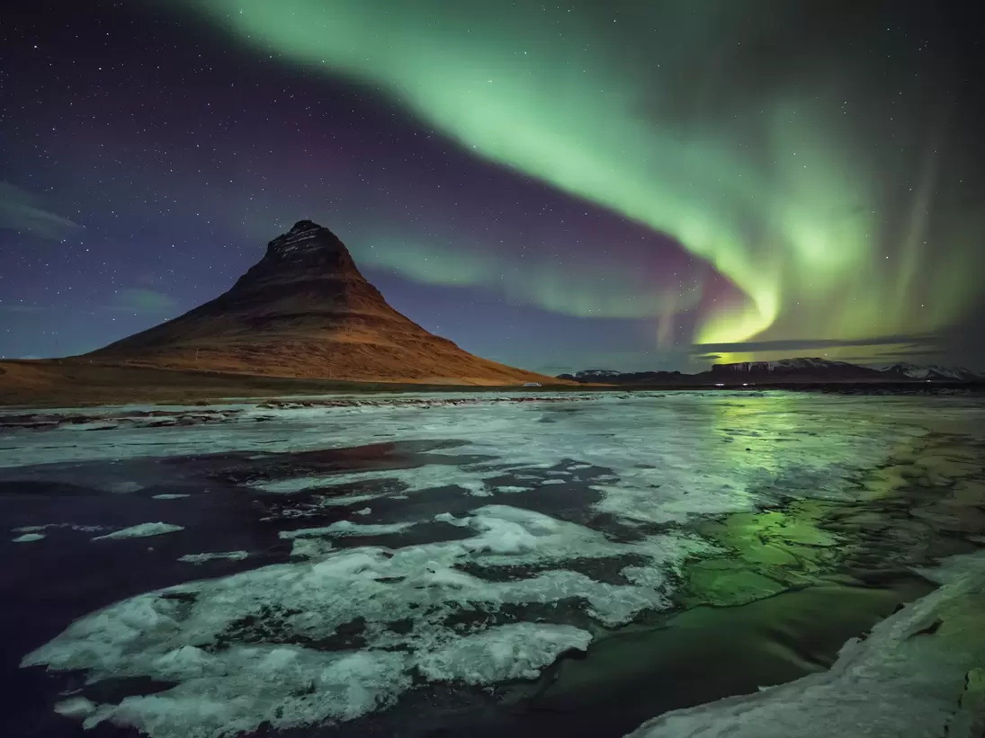 Kirkjufell mountain, Western Iceland, as the aurora really starts to pump out, illuminating the frozen landscape. ....From a superb trip with David Clapp and Antony Spencer