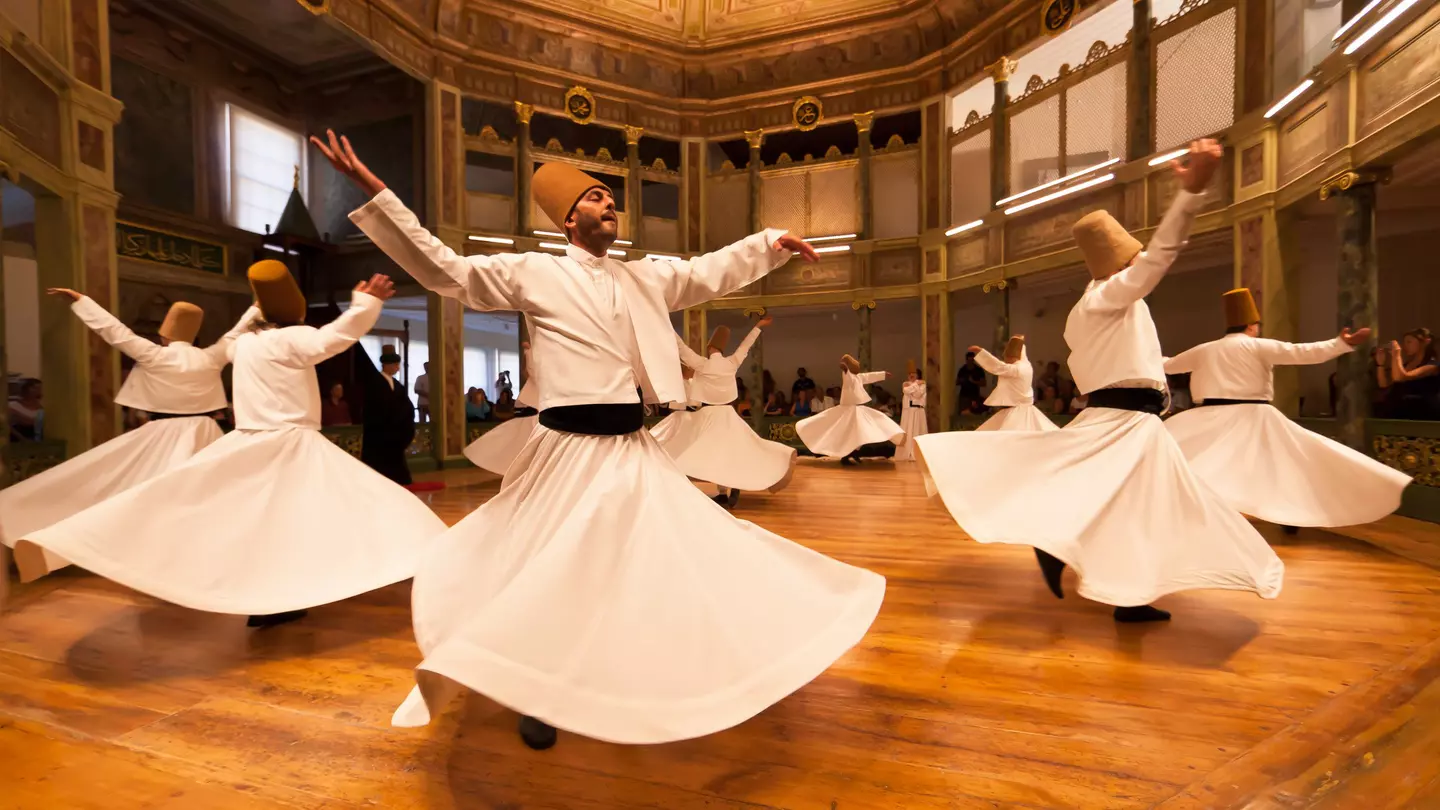 The whirling Dervishes in Istanbul, Turkey.
Istanbul, Istanbul Province, Marmara Region, Turkey, Middle East, Asia Minor, indoors, daytime, city, urban scene, group of people, people, 35-39 years, mid-adult, 30s adult, male, mid adult man, Whirling Dervishes, spinning, dancing, leisure, arms outstretched, robes, traditional clothing, hat, performance, performer, dancer, recreation, travel, travel destinations