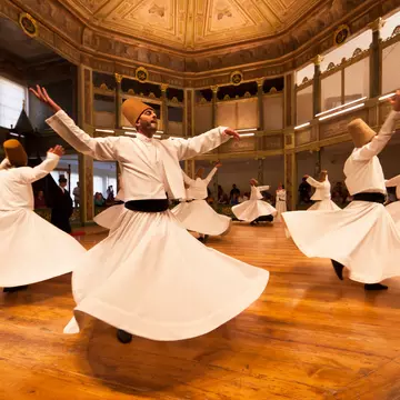 The whirling Dervishes in Istanbul, Turkey.
Istanbul, Istanbul Province, Marmara Region, Turkey, Middle East, Asia Minor, indoors, daytime, city, urban scene, group of people, people, 35-39 years, mid-adult, 30s adult, male, mid adult man, Whirling Dervishes, spinning, dancing, leisure, arms outstretched, robes, traditional clothing, hat, performance, performer, dancer, recreation, travel, travel destinations