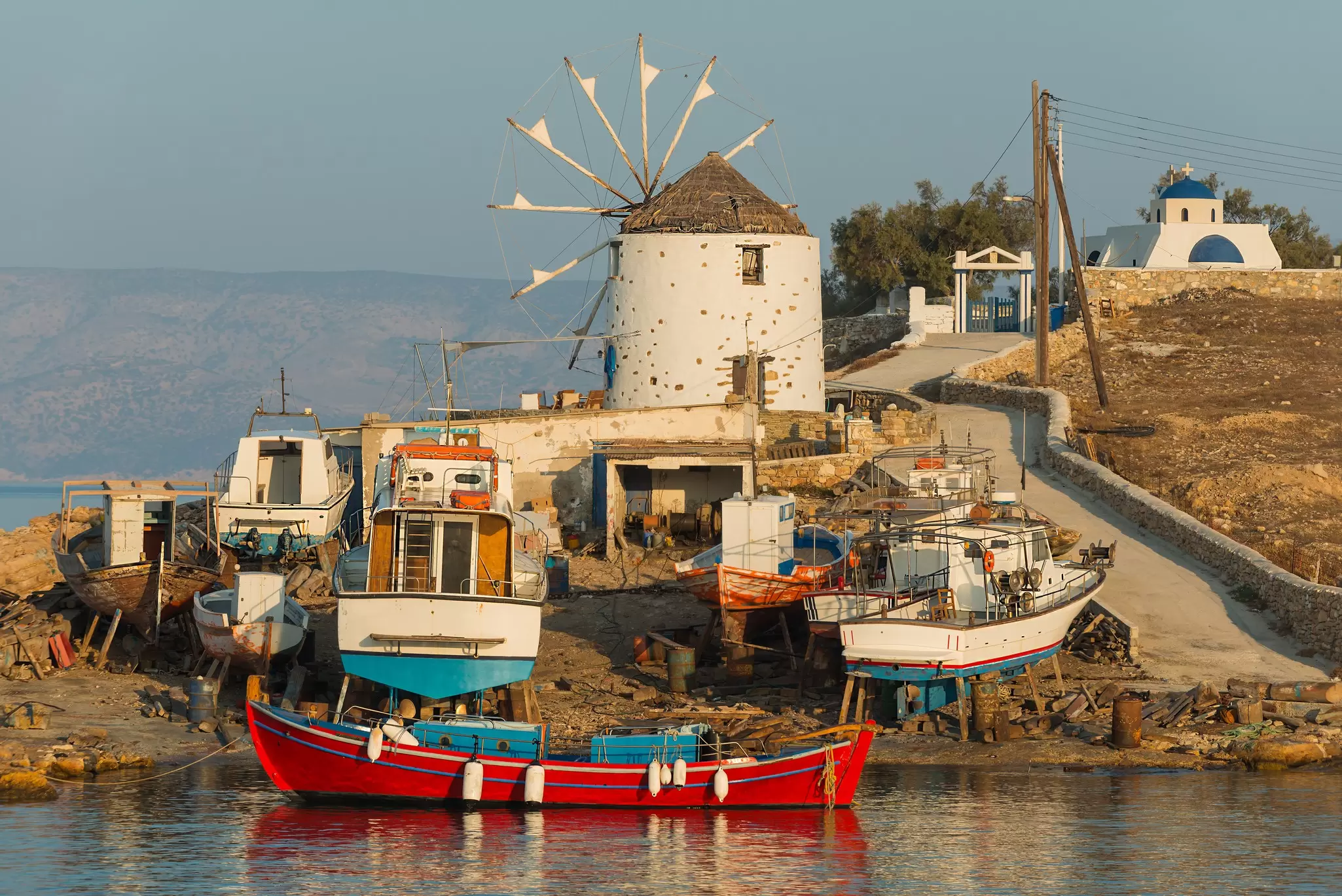 Shipyard and windmill at sunset