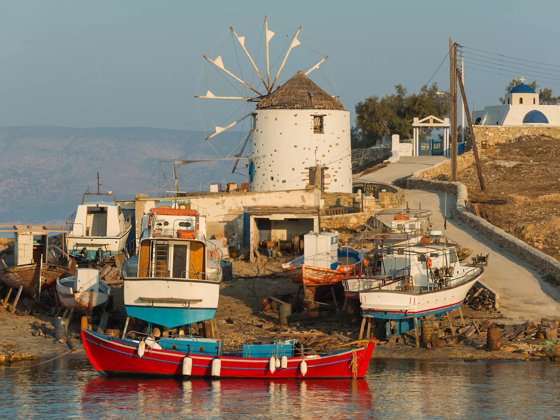 Shipyard and windmill at sunset