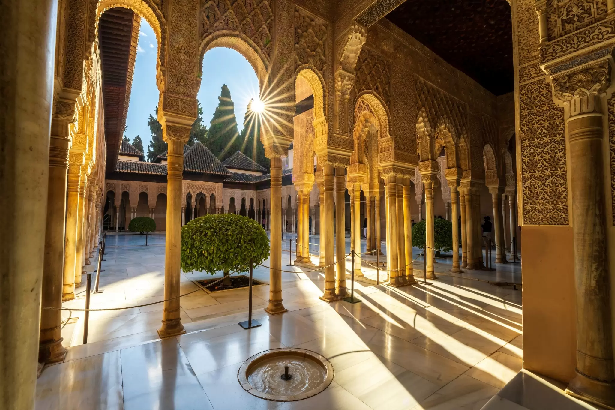 Granada, Spain, EU - March 6, 2022. Inside Alhambra Palace, interior patio courtyard, Court of the Lions with Moorish arched pillars, columns, fountain and starburst, day. A Alhambra Nasrid Palace., License Type: media, Download Time: 2024-10-03T06:33:45.000Z, User: claramonitto, Editorial: true, purchase_order: 56530, job: Global Publishing-WIP, client: Experience Andalucia 2, other: Clara Monitto