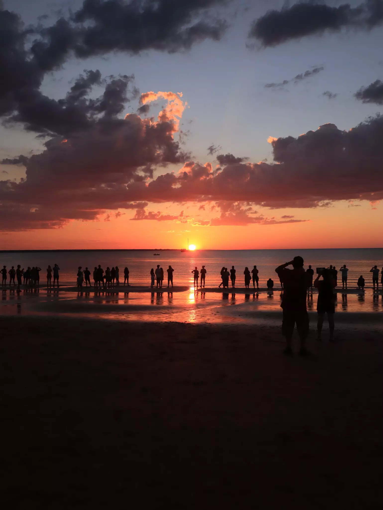 People gathered while watching sunset at Mindil Beach during early days of Dry Season.Darwin NT, Australia