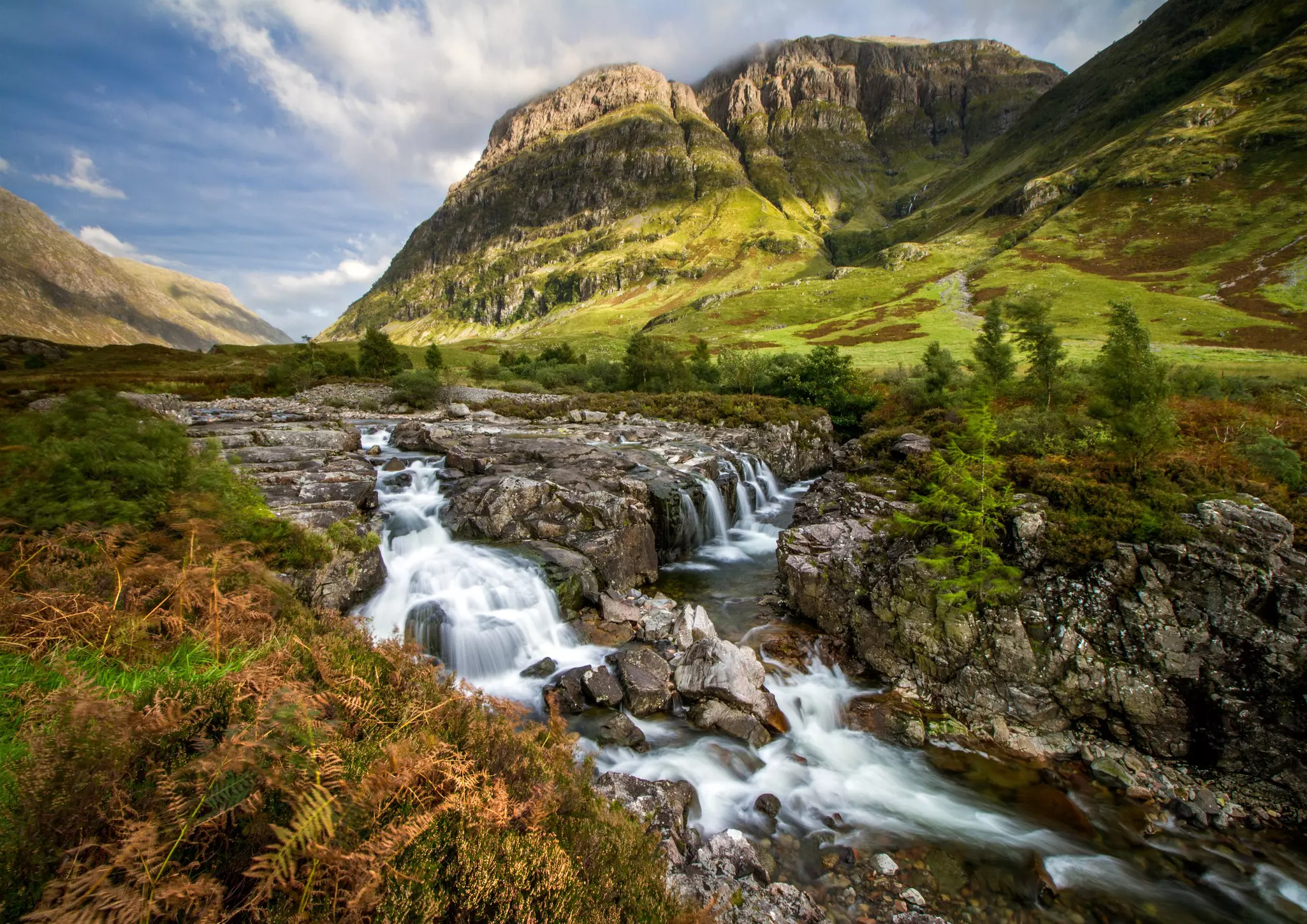 A stream cascading through the landscape in Glen Coe, Highlands, Scotland.