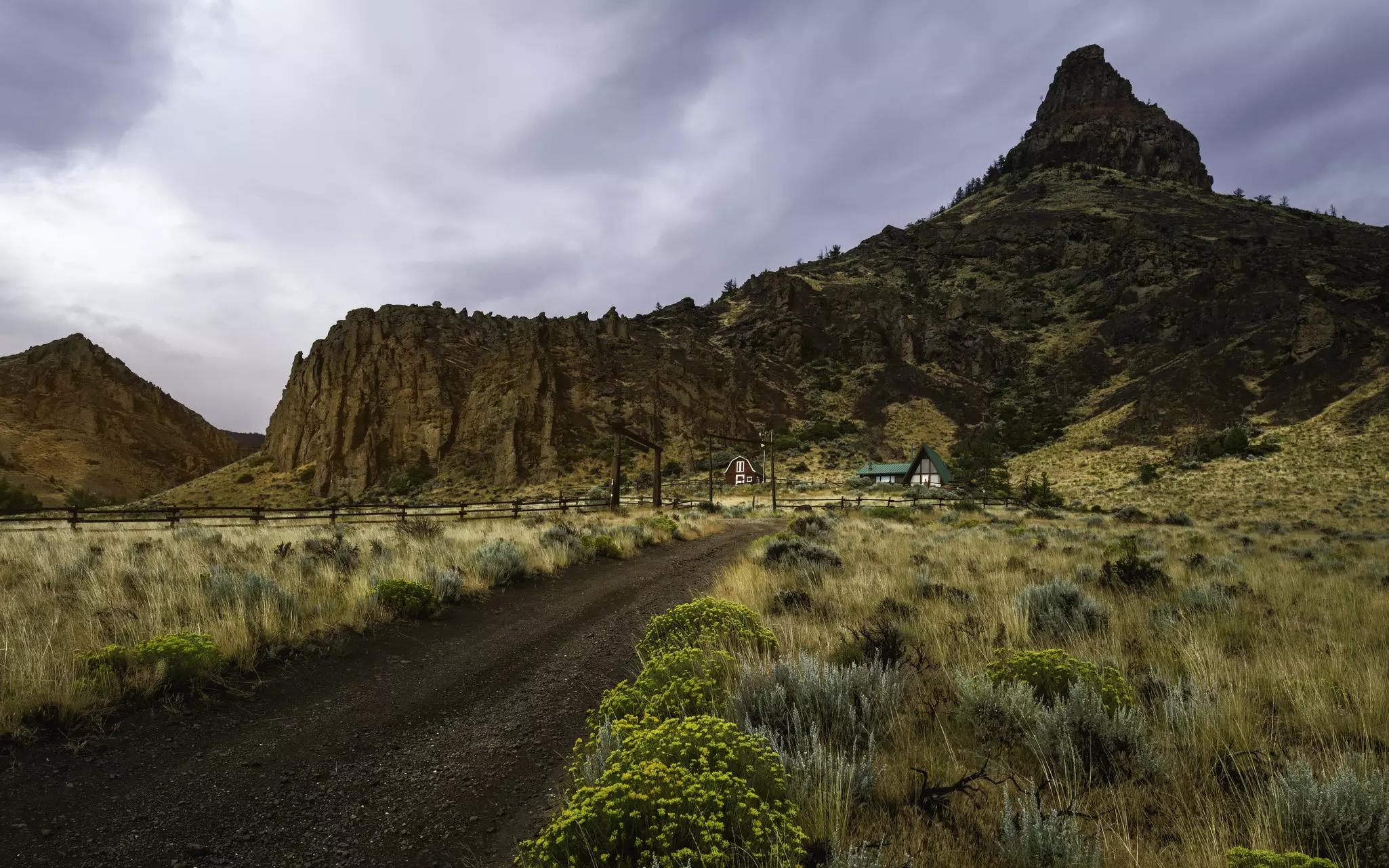 Homestead surrounded by rugged landscape, Cody, Wyoming, USA.
Horizontal Outdoors Rural Scene House Plant Fence USA Flower Cloud - Sky Summer Landscape Mountain Rock - Object Arid Climate Prairie Wyoming Cody - Wyoming Scenics Grass Overcast Dirt Road Natural Parkland Remote No People Photography Extreme Terrain Sagebrush Buffalo Bill Cody 2015 Buffalo Bill State Park