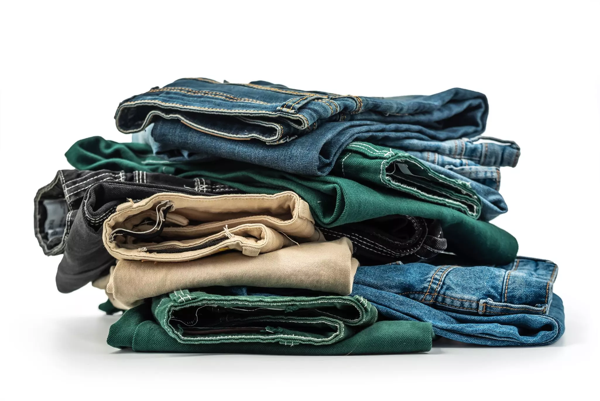 A stack of photo books and the top one is opened to a two-page spread of a live oak alley with a path running under the trees.