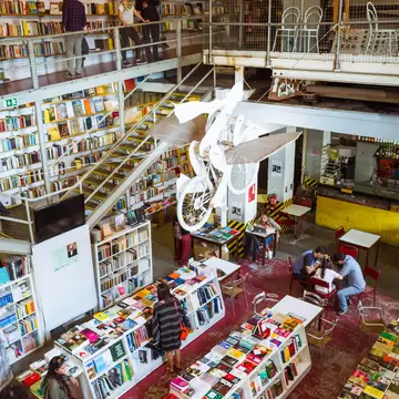 People reading and browsing through the bookstore within the LX factory creative hub complex in Lisbon, Portugal.