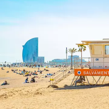 View of the lifeguard tower on Barceloneta beach on a sunny day in Barcelona, Spain.