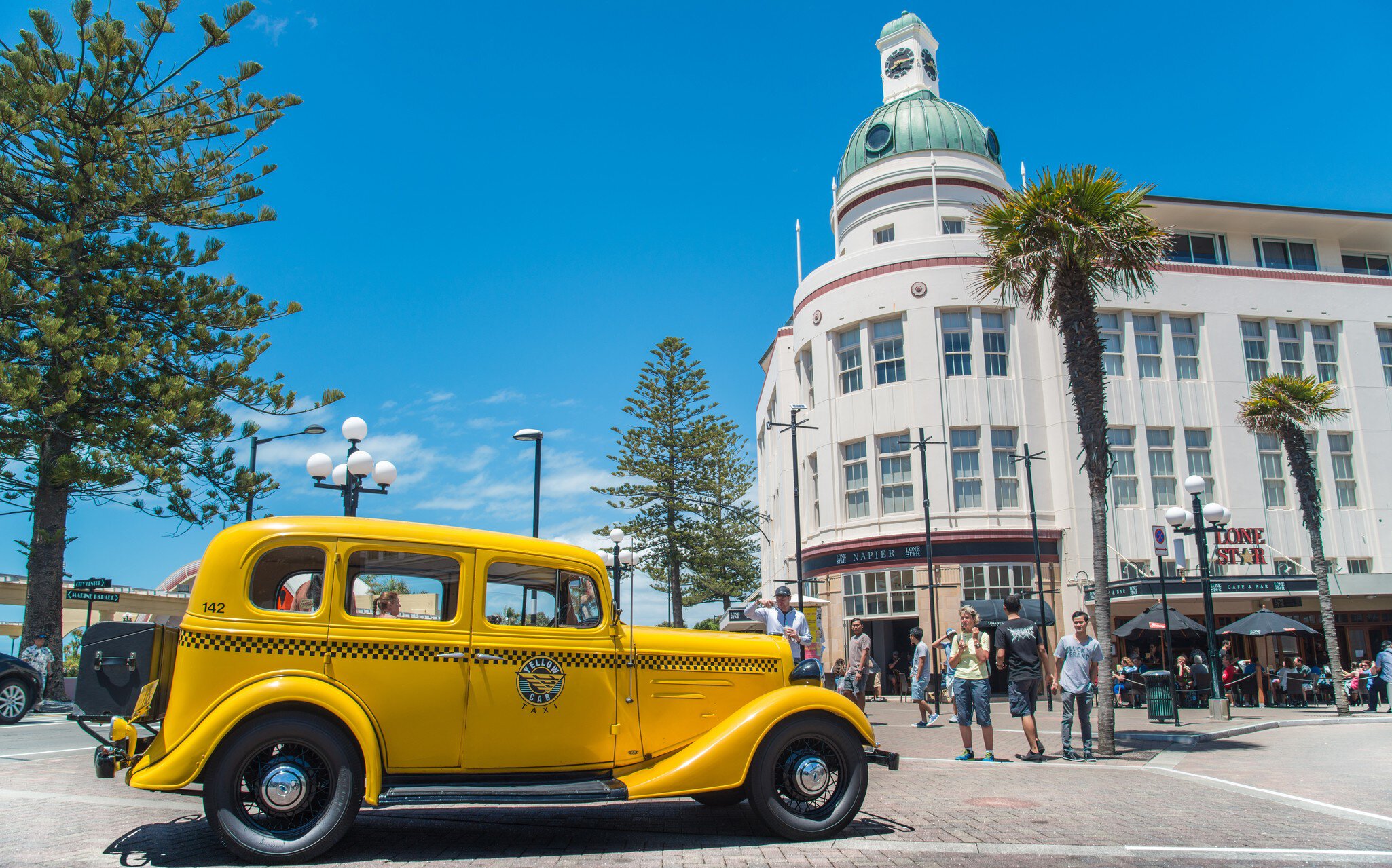 Napier, New Zealand -December-30-2017 : The classic cars tour parked in front of T&G building an iconic art deco landmark building in Napier town, New Zealand.