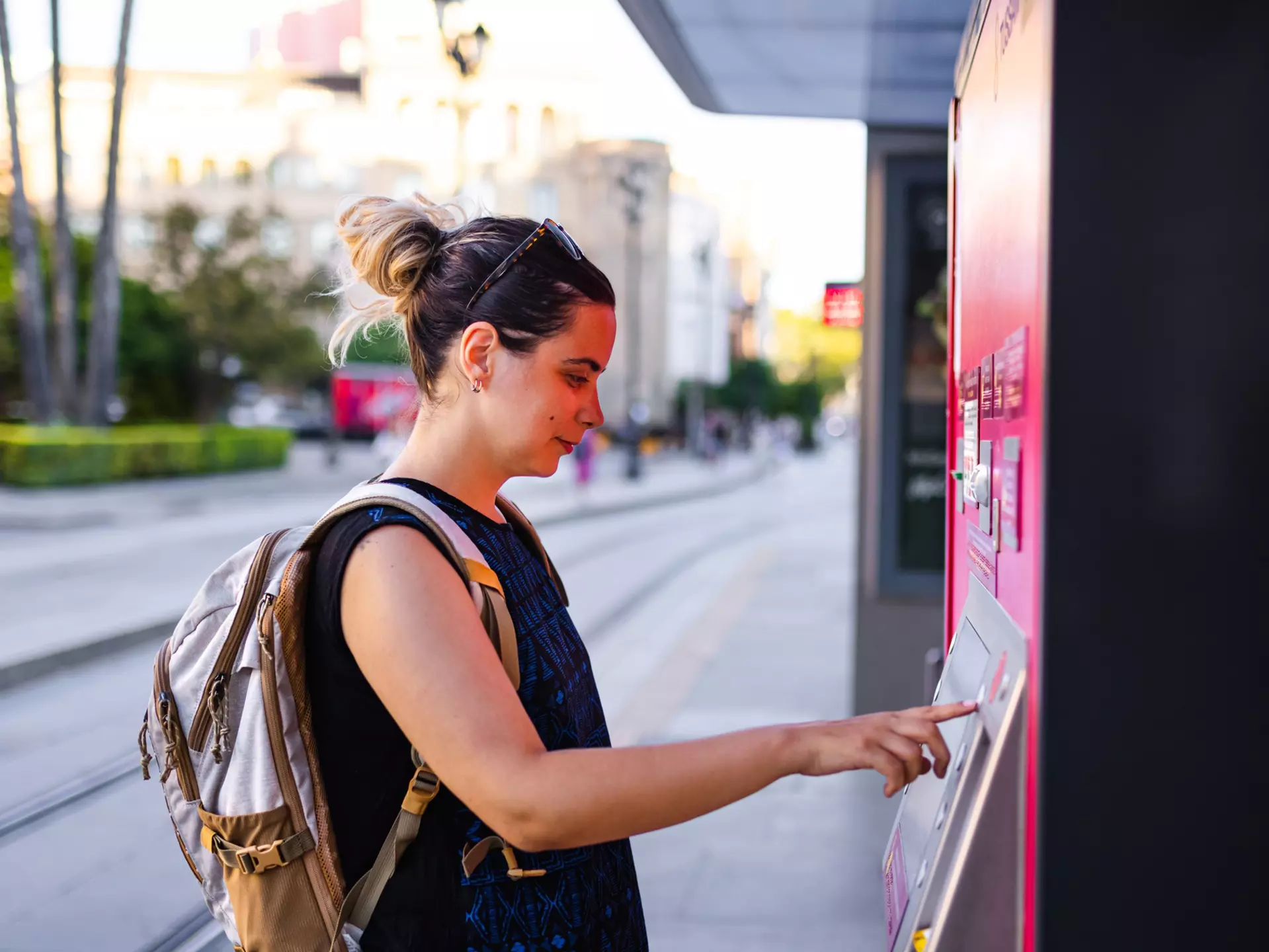 Young woman buying ticket for transportation