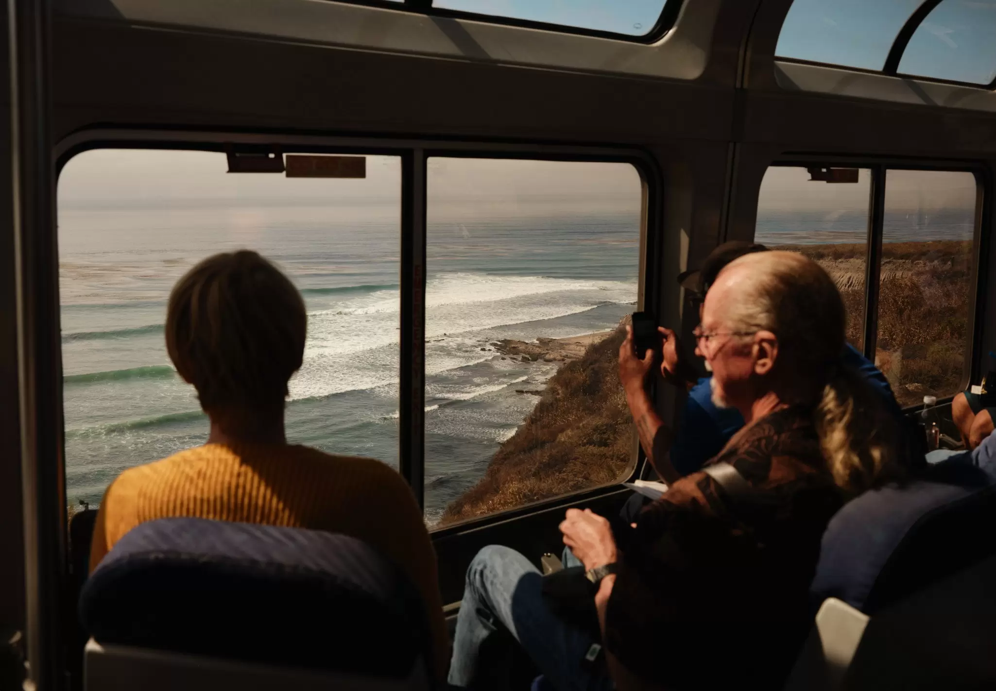 Passengers in the observation car cruise alongside the coastline of the Santa Ynez Mountains, north of Santa Barbara, CA.
