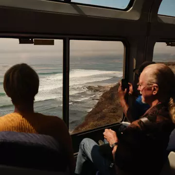 Passengers in the observation car cruise alongside the coastline of the Santa Ynez Mountains, north of Santa Barbara, CA.