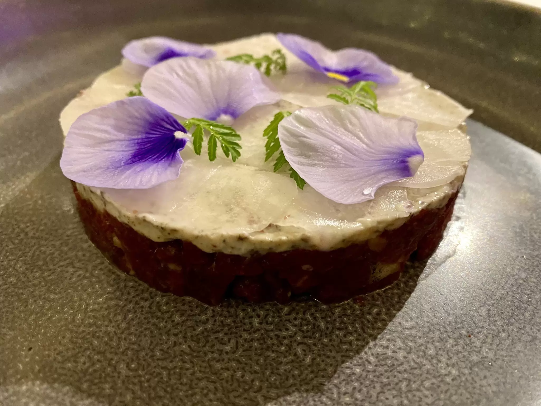 Horsemeat tartare with eel, decorated with flower petals, at Qazaq Gourmet in Astana, Kazakhstan.