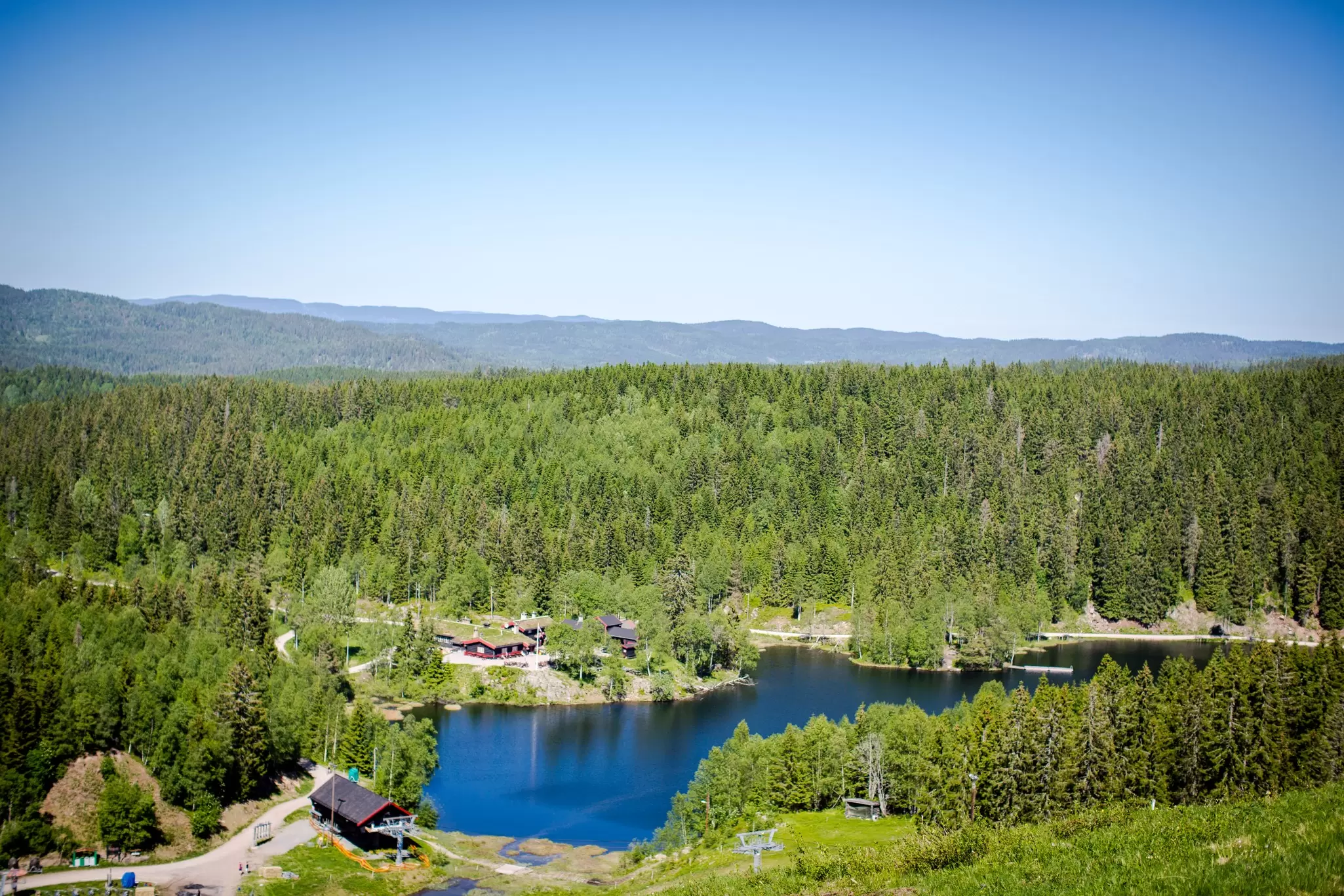 A lake surrounded by dense woodland on a summer's day: Nordmarka, near Oslo