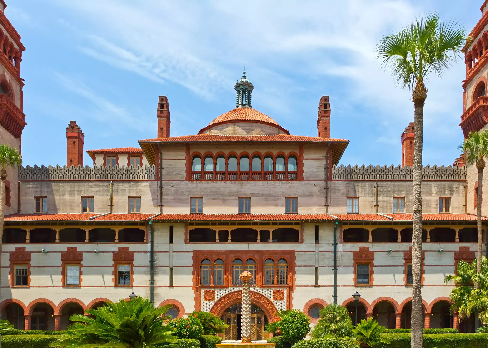 A large symmetrical building with grand arches and a central dome built in a Moorish style.