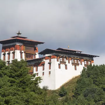 Jakar Dzong in mountains.