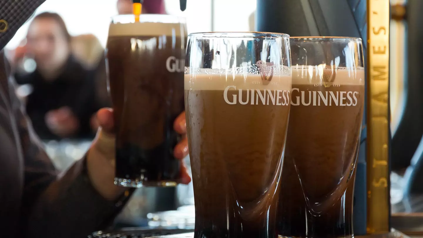 Four pints of half drunk Guinness on the counter in an Irish pub