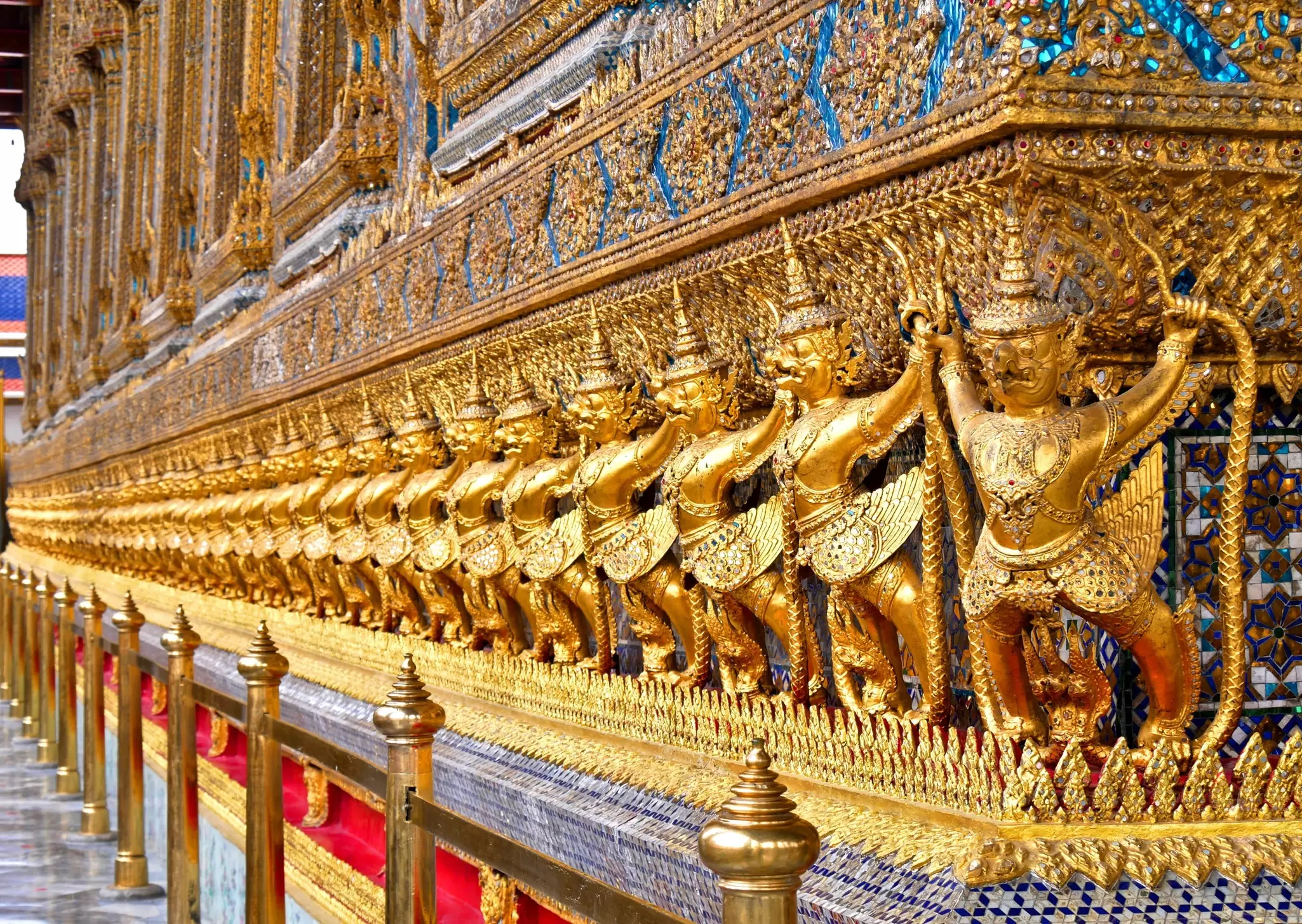 Close-up of the golden decorations on the exterior of the Ordination Hall at Wat Phra Kaew in Bangkok, Thailand.