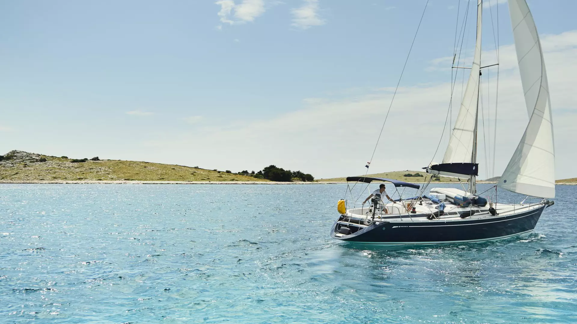 Yacht sails past Ravni Žakan, one of 89 small islands within Croatia’s Kornati National Park.