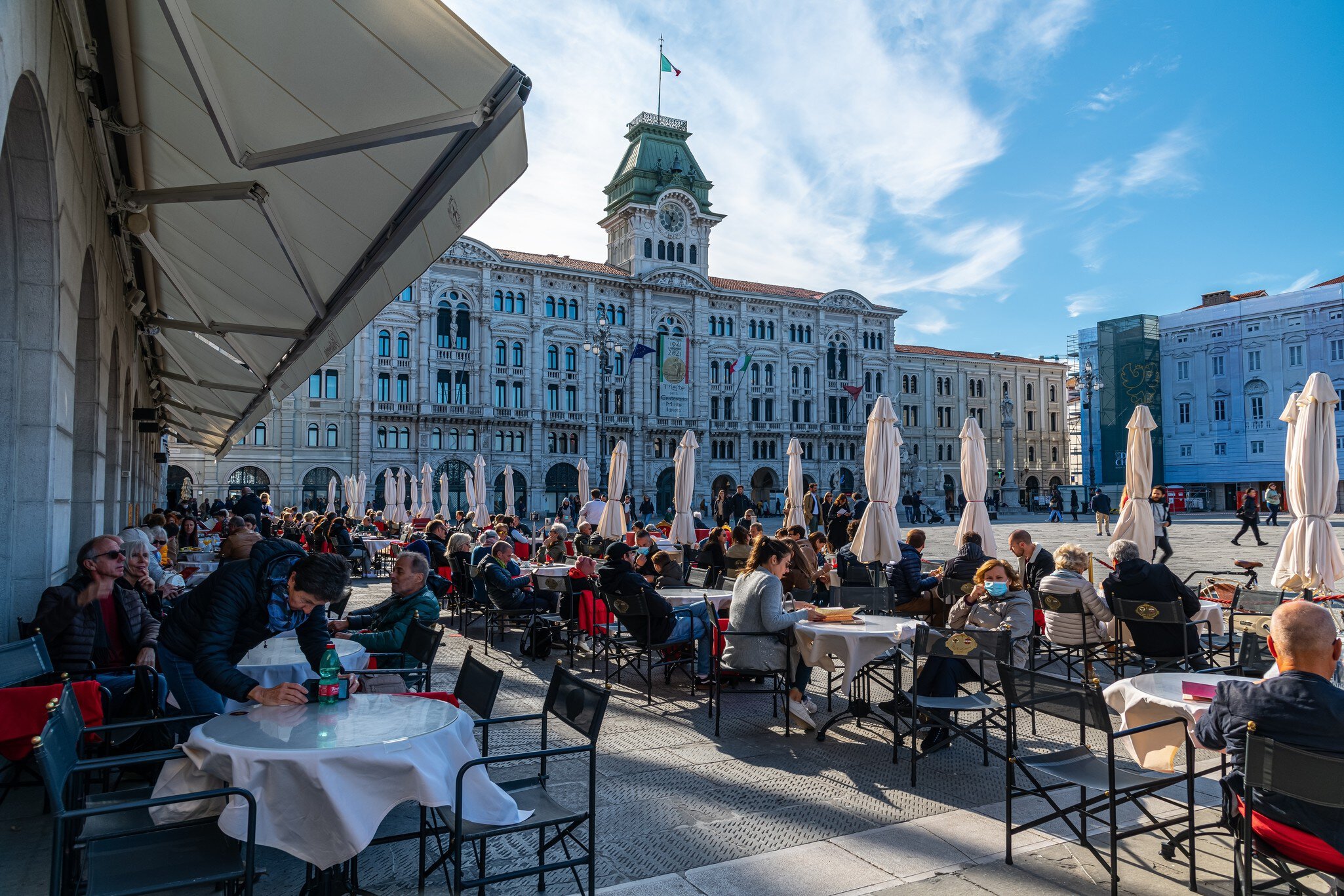 Trieste, Italy 16.10.2021: People enjoyin coffee at famous coffeeshop at the Piazza dell’Unità d’Italia, the main square in Trieste on sunny october day; Shutterstock ID 2062626323;