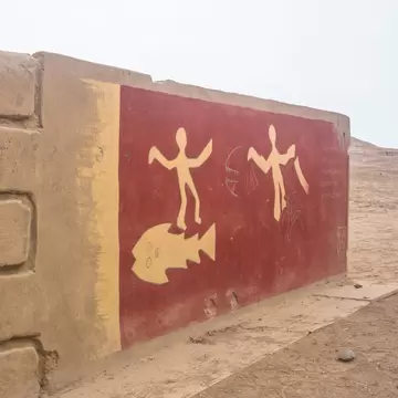Pachacamac archeological site with original painting on a stone wall outside of Lima, Peru.