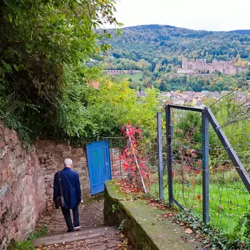 A man walking down the Heidelberg Philosopher's Walk (Philosophenweg) in Heidelberg city, Germany.
