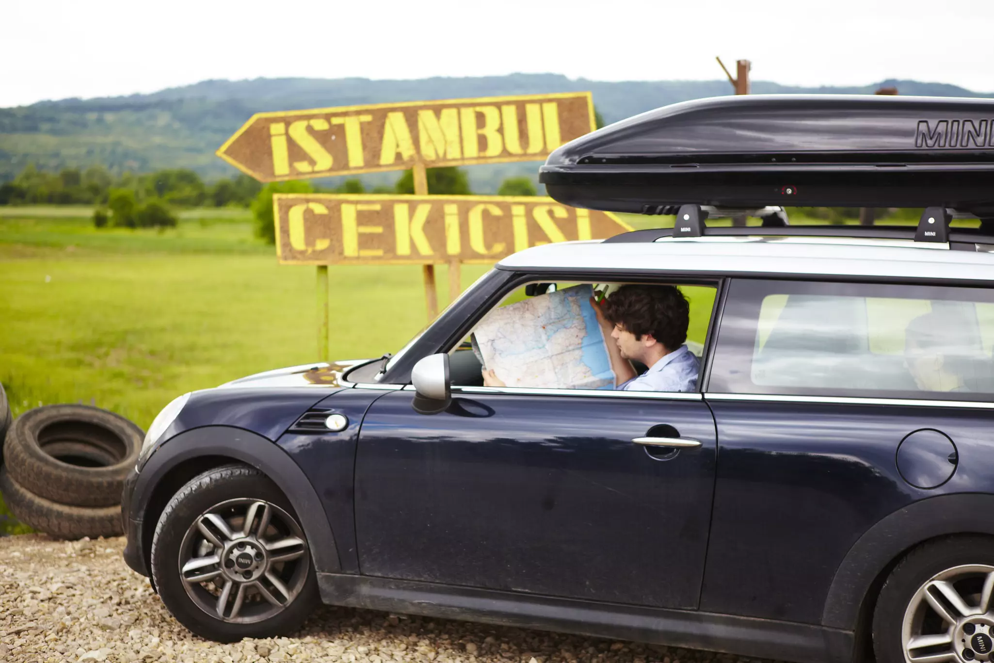 Man looking at a map inside a car