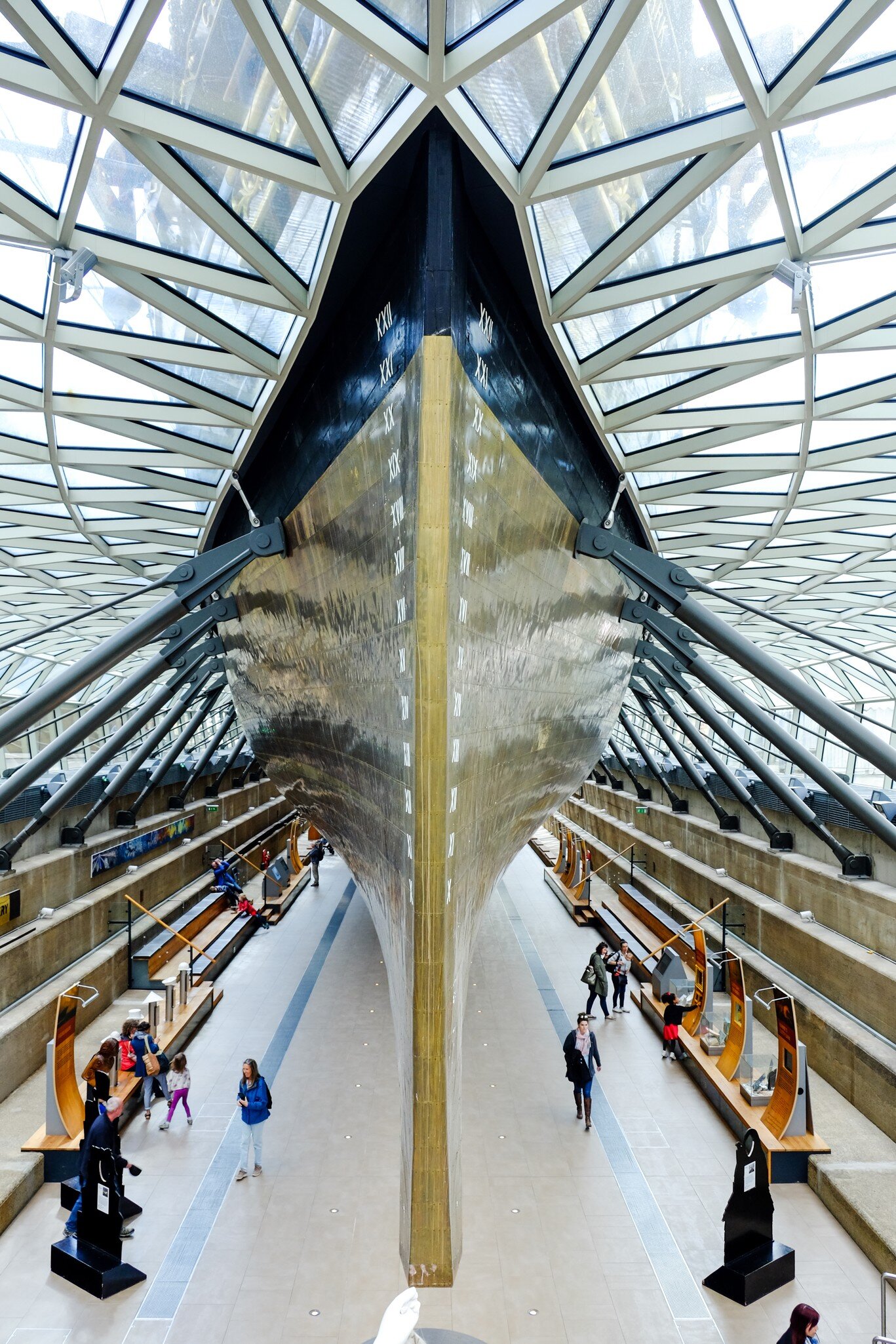 LONDON, UNITED KINGDOM - APRIL 10, 2017: Tourists at the exhibition underneath Cutty Sark's keel. Cutty Sark was preserved as a museum ship and become a popular tourist attraction in Greenwich.  License Type: media  Download Time: 2024-05-06T03:09:33.000Z  User: pinkjozie64  Is Editorial: Yes  purchase_order:   