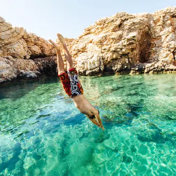 Cyclades, Greece, Lonely Planet Traveller magazine, Mykonos, Naxos, Paros, Santorini, Issue 94, Great Escape, October 2016, Extra
Man diving into clear water at Paros, Greece