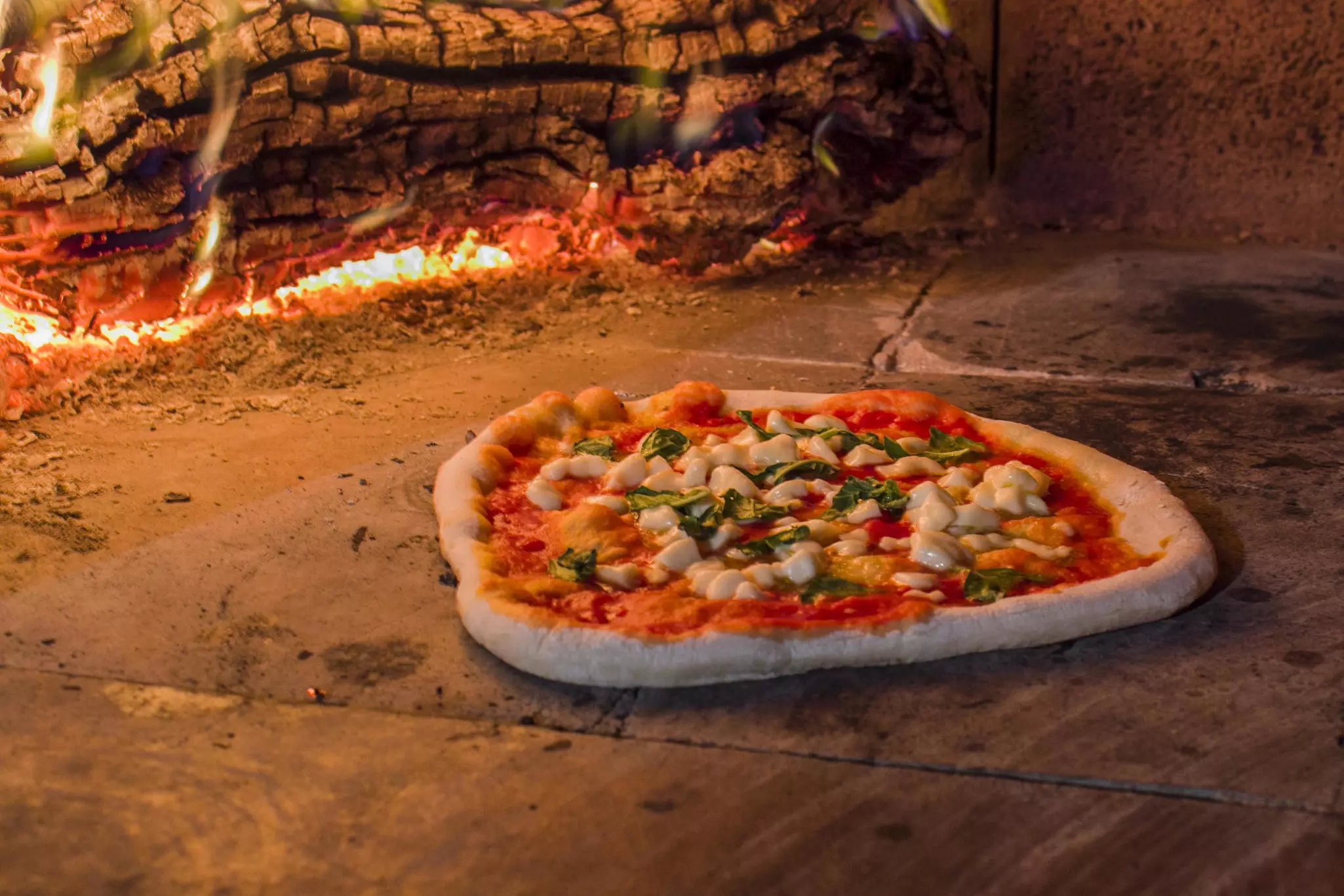 Margherita pizza in a wood oven in Naples, Campania, Italy.