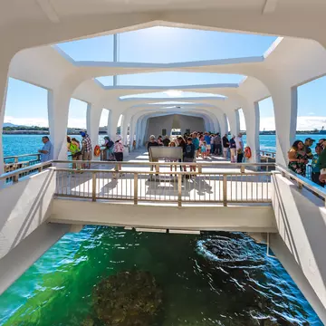 Pearl Harbor, Hawaii, USA - January 8, 2017: Accessible only by boat, the USS Arizona Memorial straddles the sunken hull of the battleship without touching it. ; Shutterstock ID 1252026778;