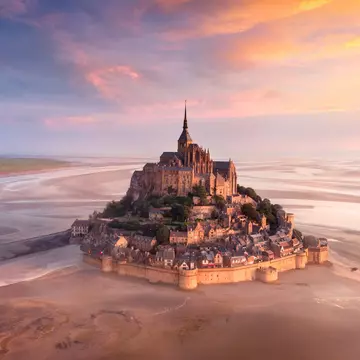 Sunrise over the monastery of Mont Saint-Michel.
