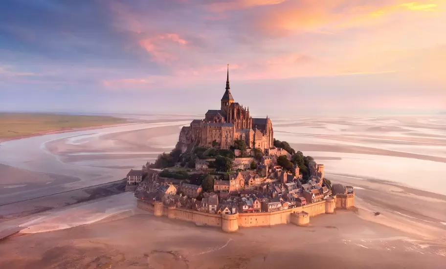 Sunrise over the monastery of Mont Saint-Michel.