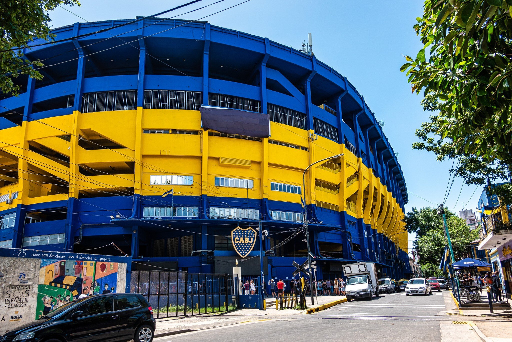 Exterior of Museo de la Pasión Boquense and La Bombonera soccer stadium, large blue and yellow facade. Boca Juniors in La Boca, Buenos Aires in Argentina.
