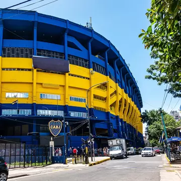 Exterior of Museo de la Pasión Boquense and La Bombonera soccer stadium, large blue and yellow facade. Boca Juniors in La Boca, Buenos Aires in Argentina.