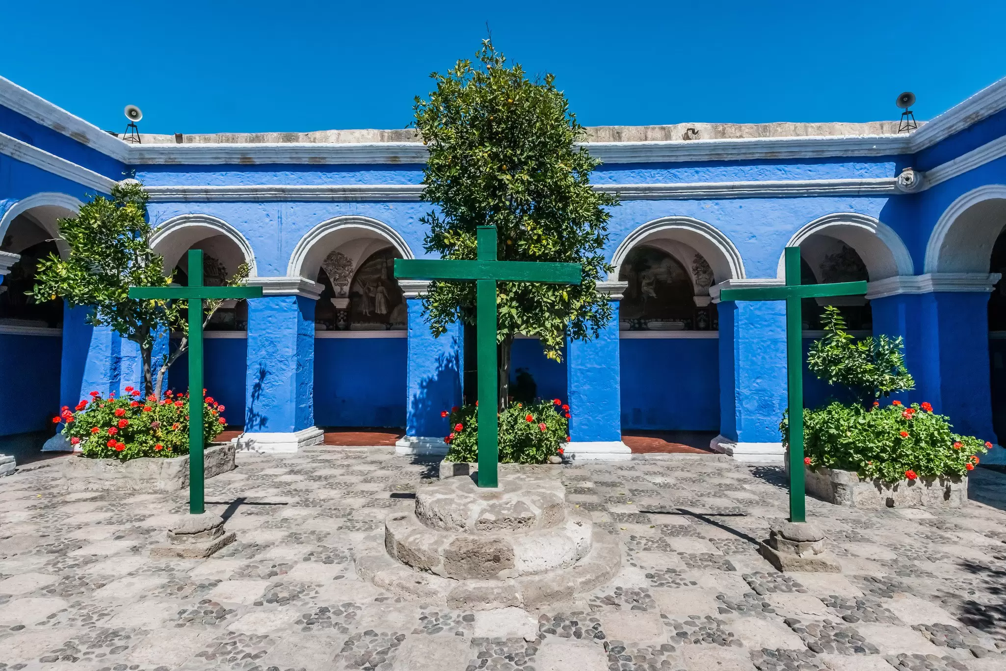 View of blue cloisters and three crosses at the Santa Catalina monastery in Arequipa, Peru.