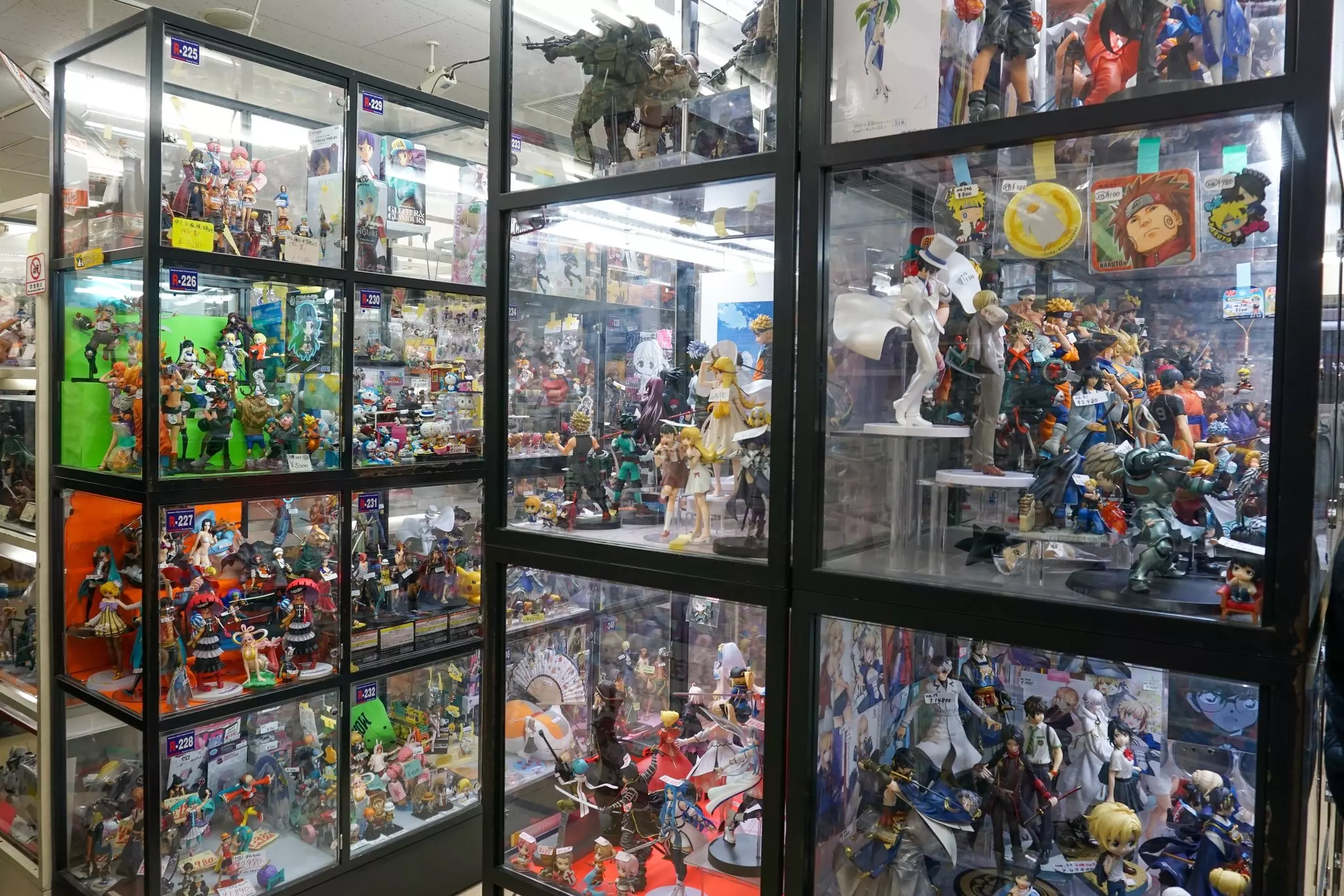 Glass cases outside a shop are filled with figurines and other toys.