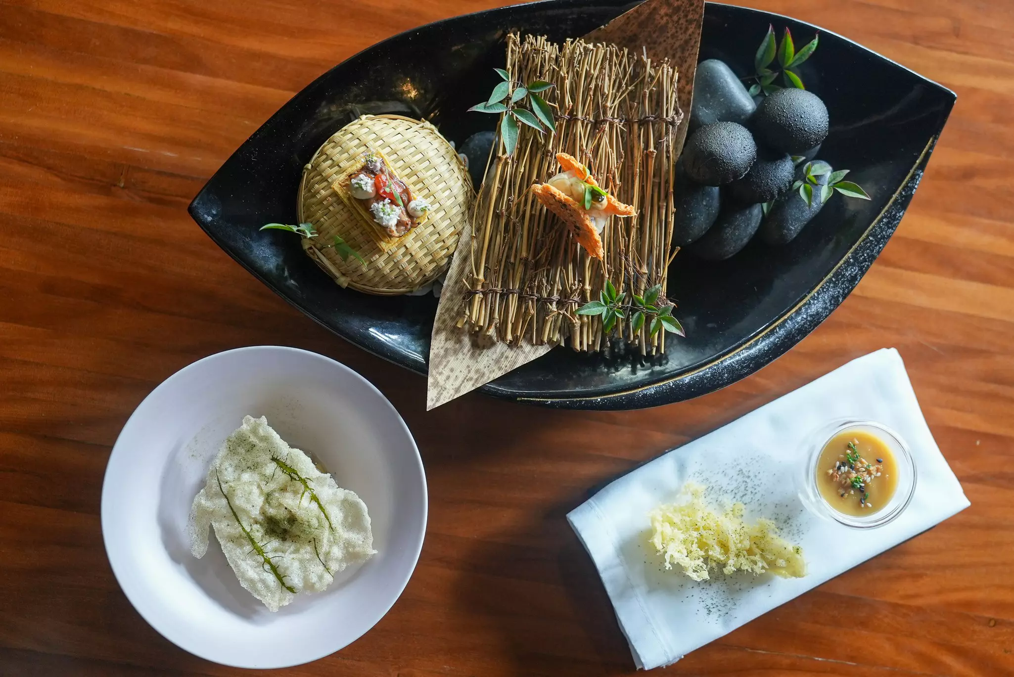 Gourmet dishes at a fine-dining restaurant are photographed from above.